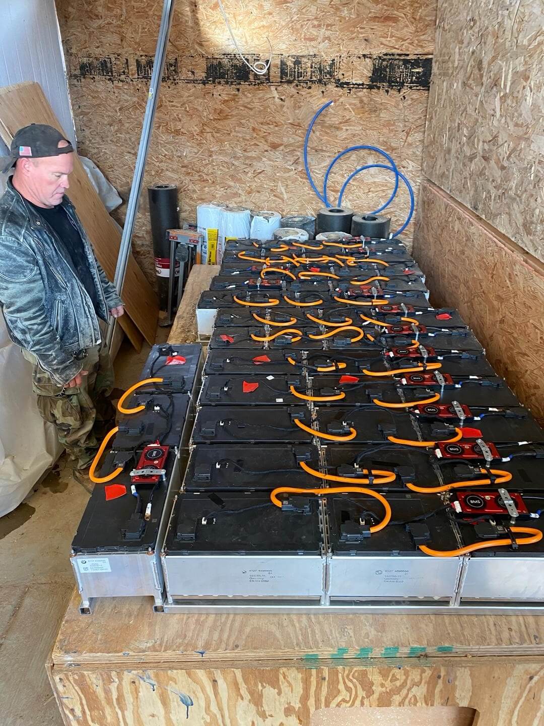 Rob examining battery groups constructed by Gabe before installation in the battery house