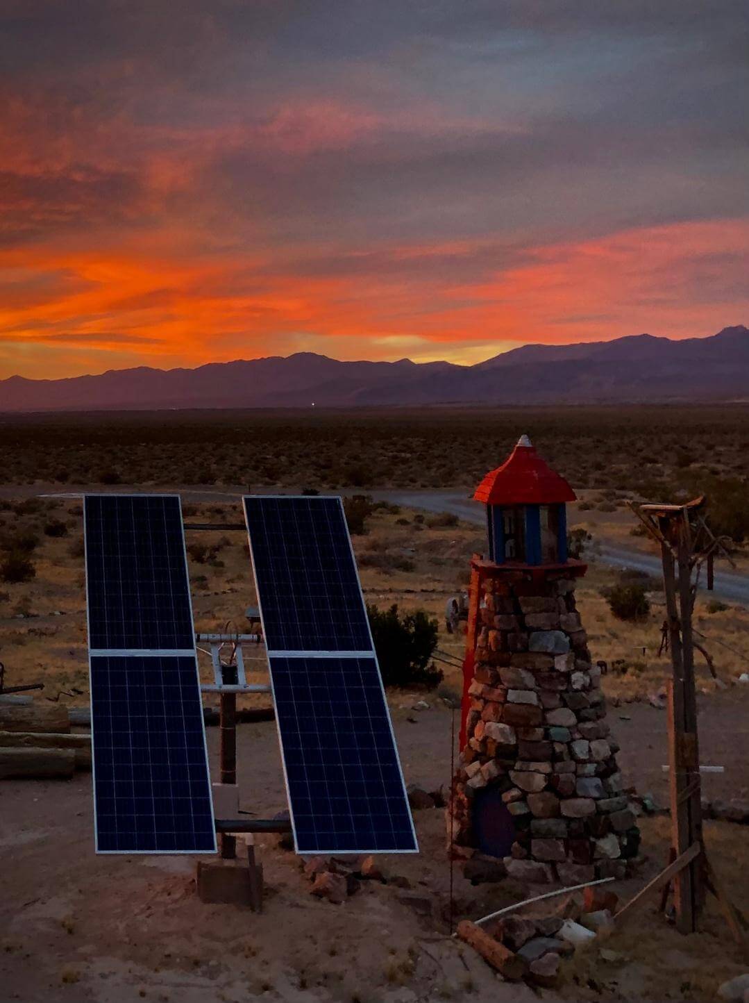 Sunbaked Farm Lighthouse at sunset with solar panels